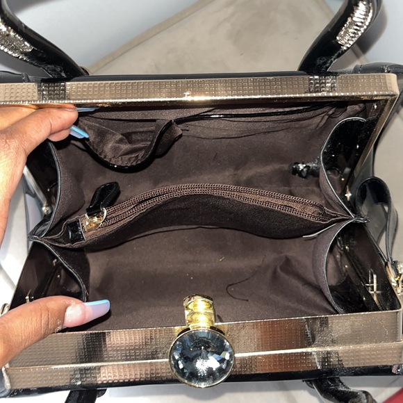 Cute handbag. Medium sized, black bag with gold accents, firm and glossy casing. - Picture 3 of 3